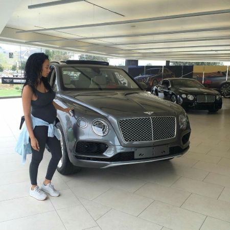 Draya Michele poses besides a Bentley Continental.